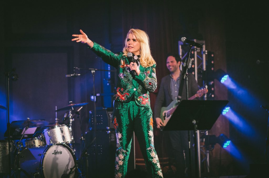 Paloma Faith on stage wearing a green outfit.