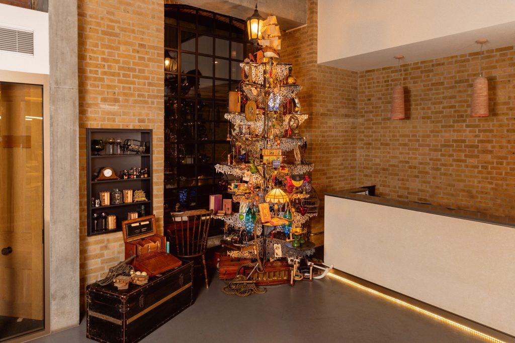 A highly decorated steel Christmas Tree in a hotel lobby