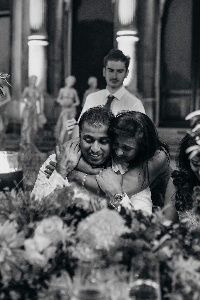 A monochrome photo of man and woman hugging