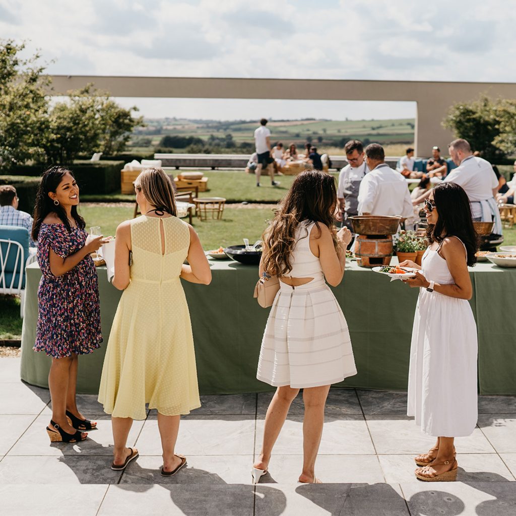 People in front of a picnic table and lawn