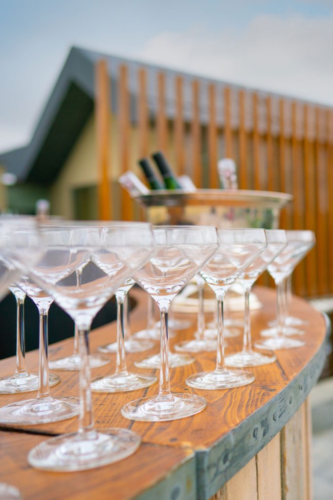 Martini glasses set on a rustic wooden circular bar