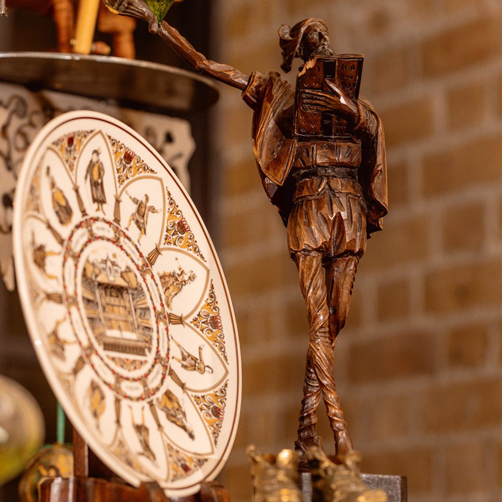 A plate with Shakespeare figures painted on its surface and a wooden carved Shakespeare figure