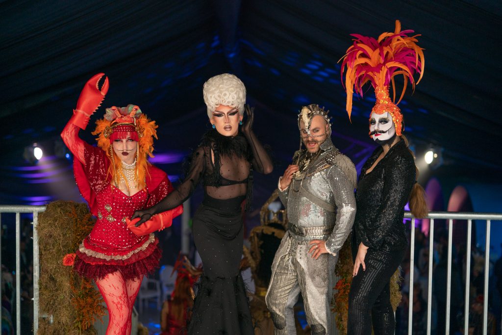 Four actors in surrealist costumes