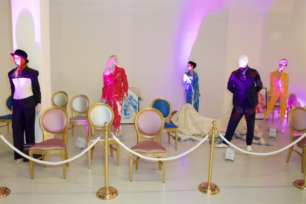 Mannequins behind ropes and stanchions.