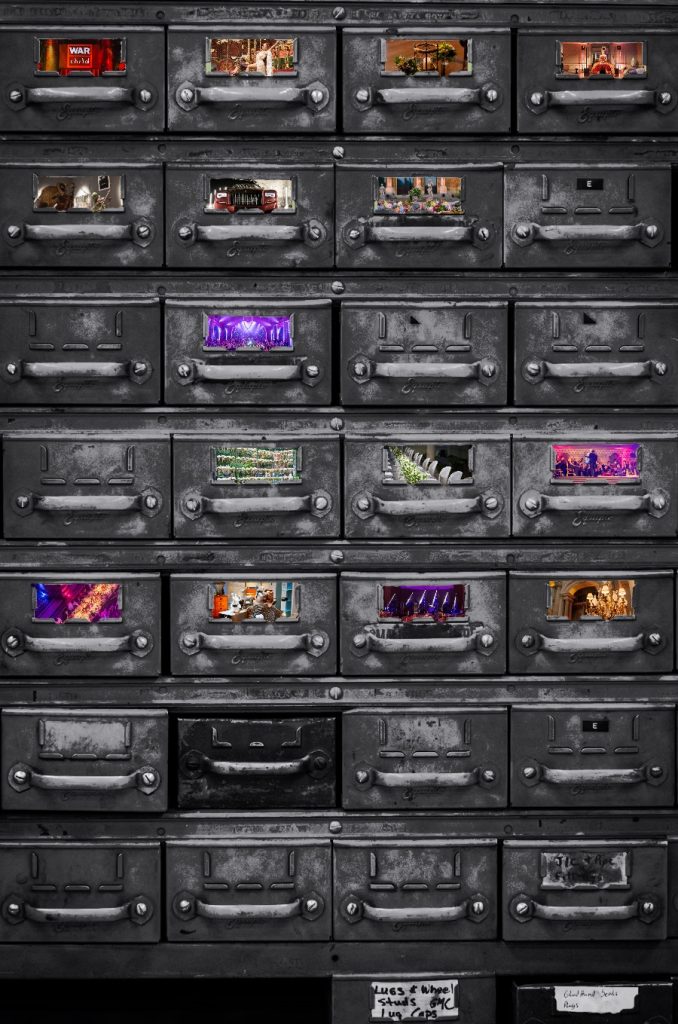 A filing cabinet of draws, with some draw windows removed and replaced with colourful photographs. Immersive Events Agency.