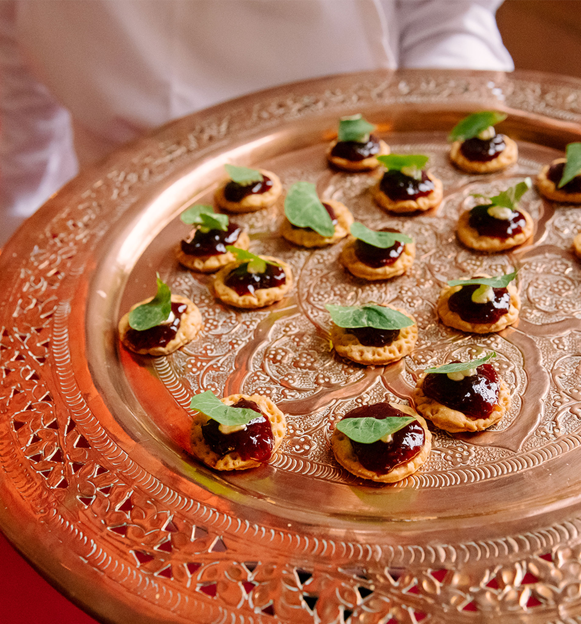 Tray of canapés on a bronze plate.