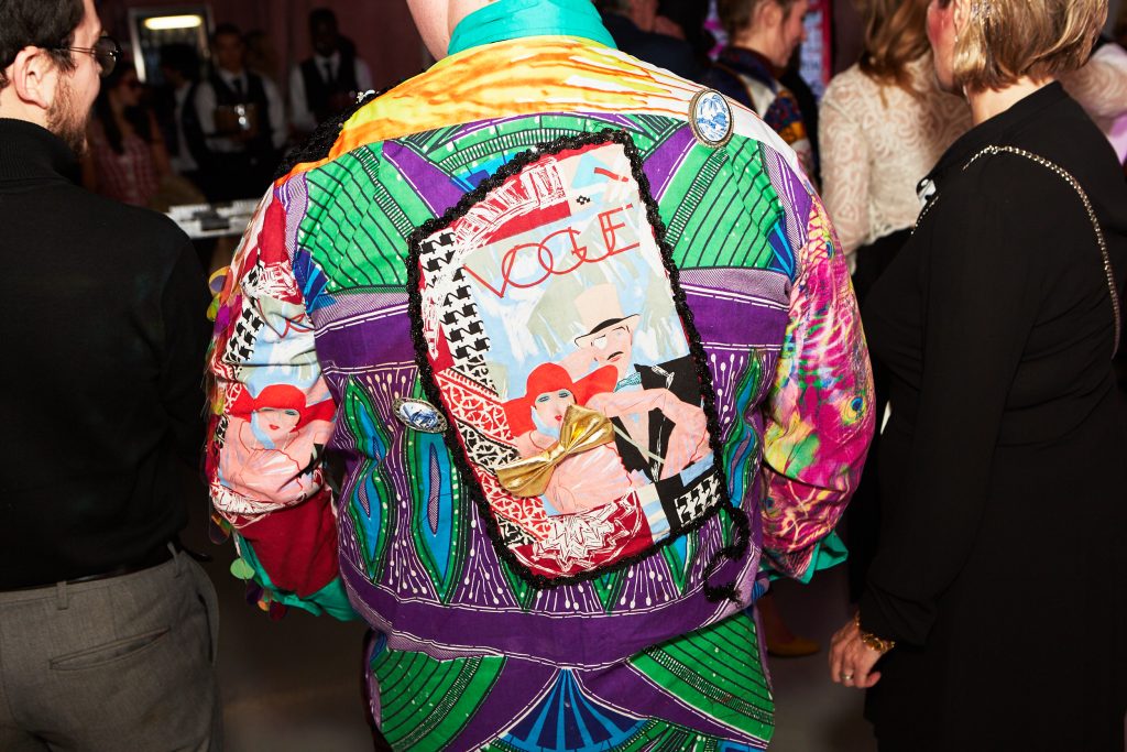 A shirt of mismatched patterns with the word VOGUE on the back.