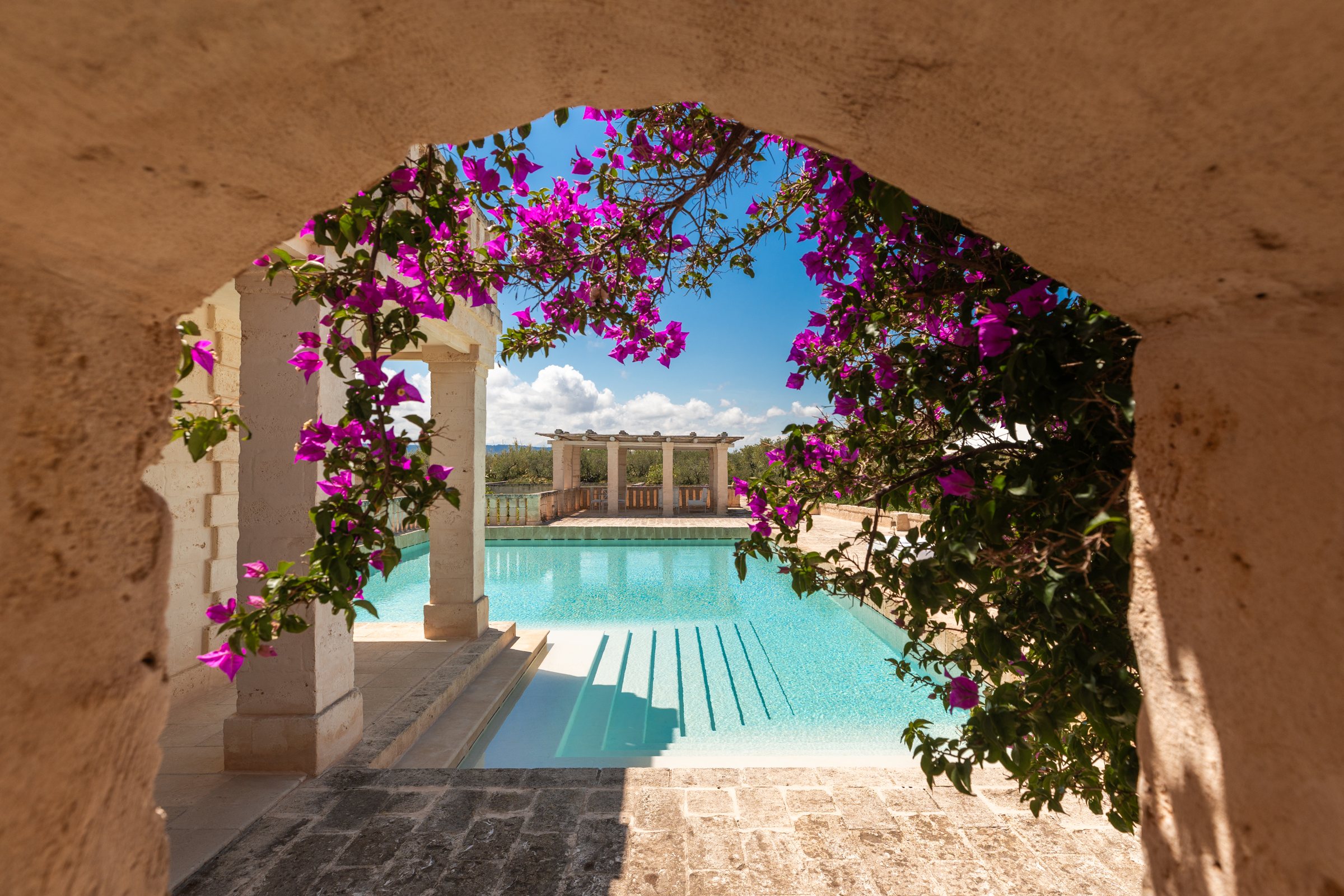 An arch of bougainvillea framing the pool.
