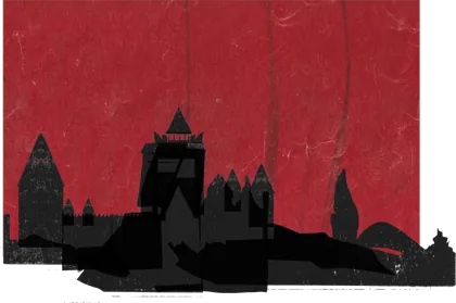 A castle on a hill against a red sky, in silhouette