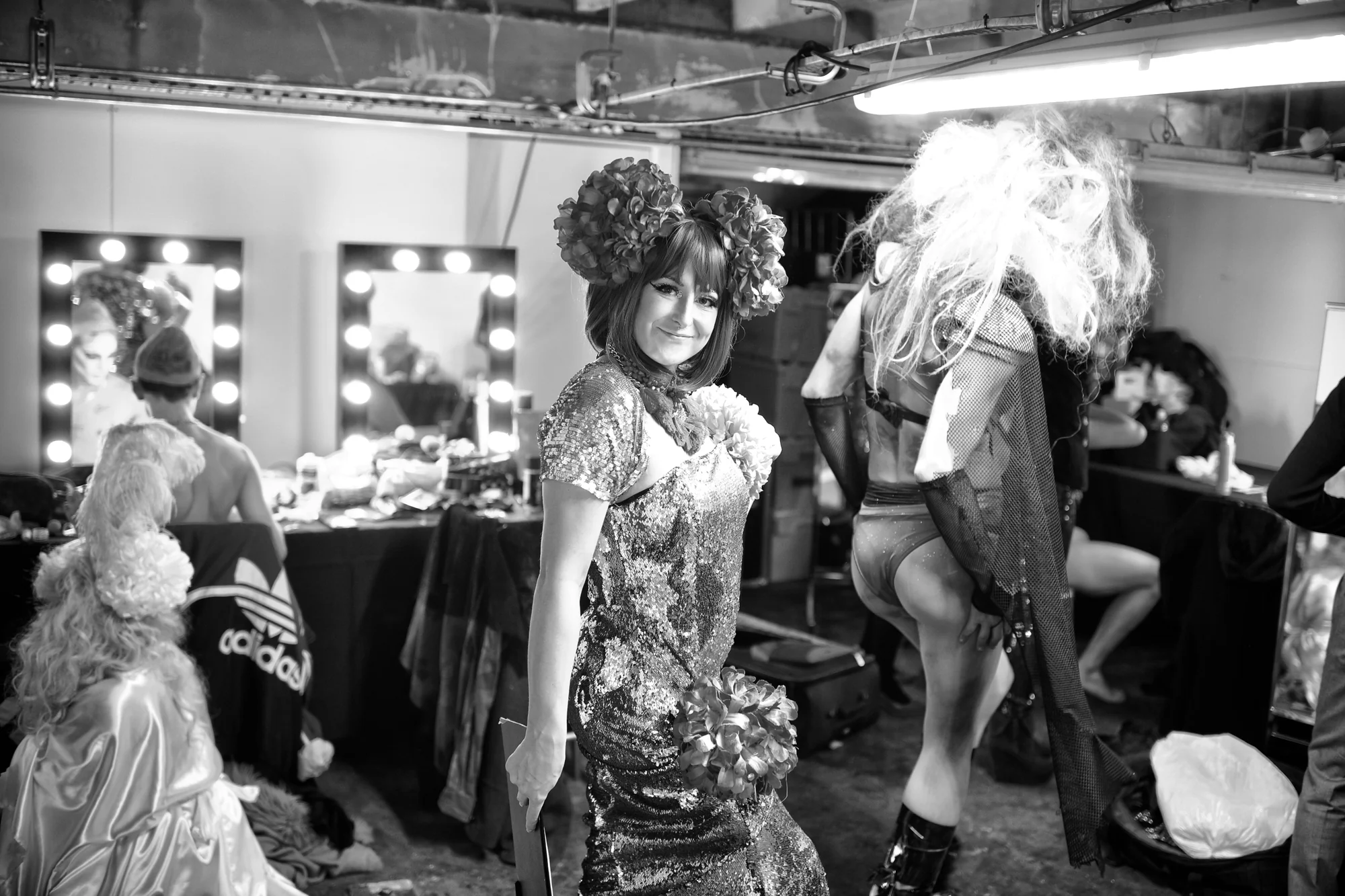 In black and white, performers getting ready at the dressing mirrors before the guests arrived.