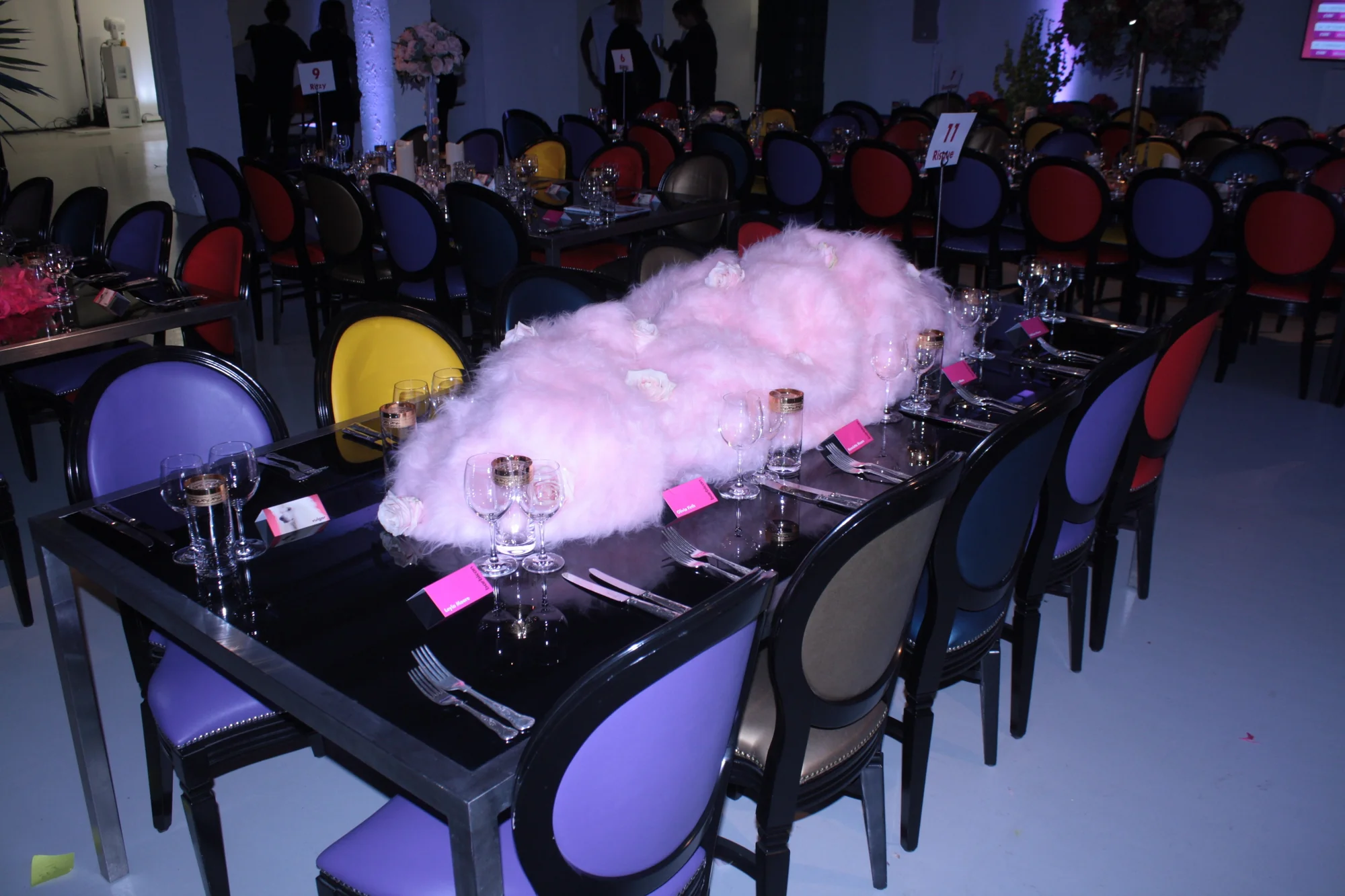A table dressed with a great cloud of pink candy floss down the middle of it.