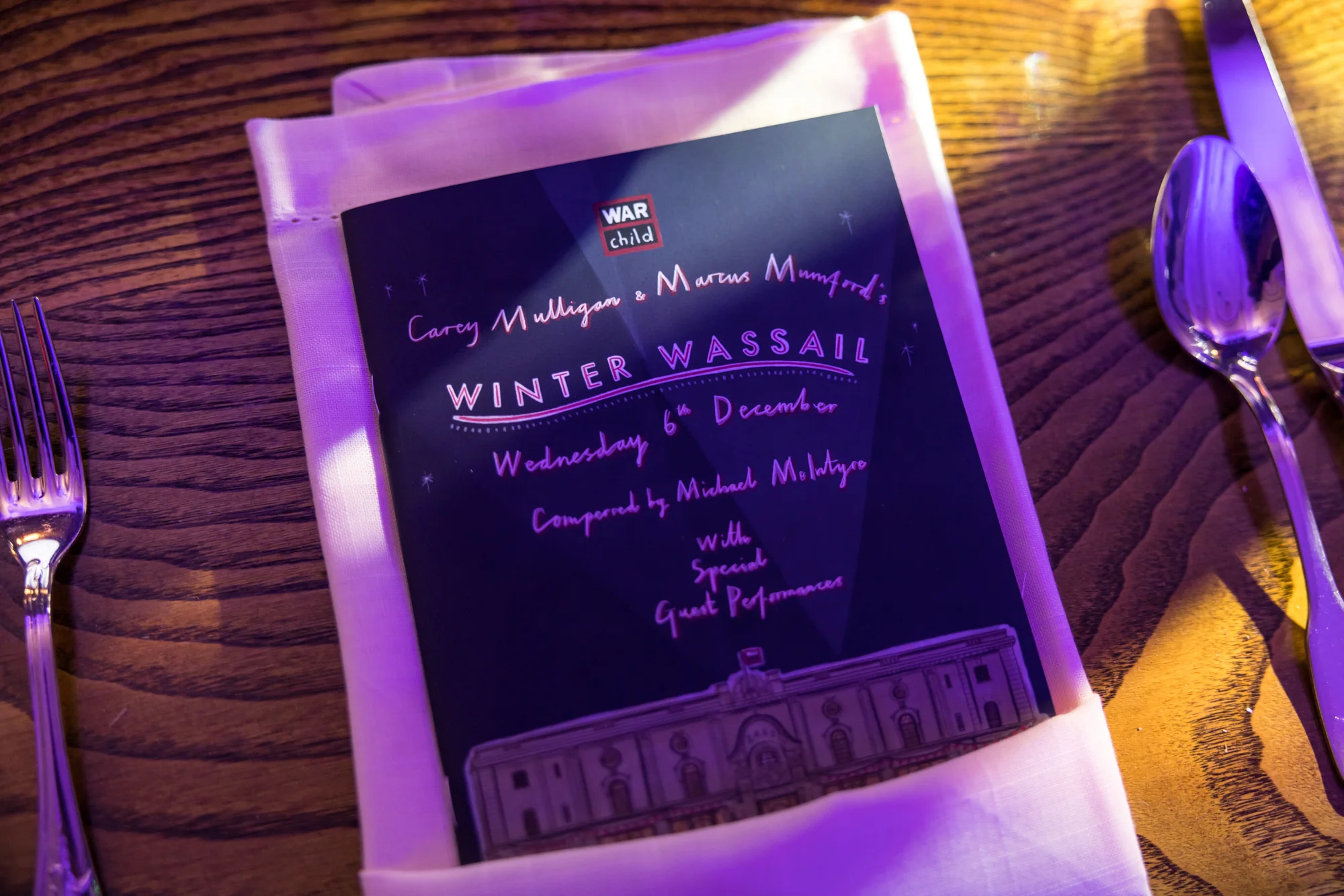 The Winter Wassail programme laid on a place setting beside the cutlery.
