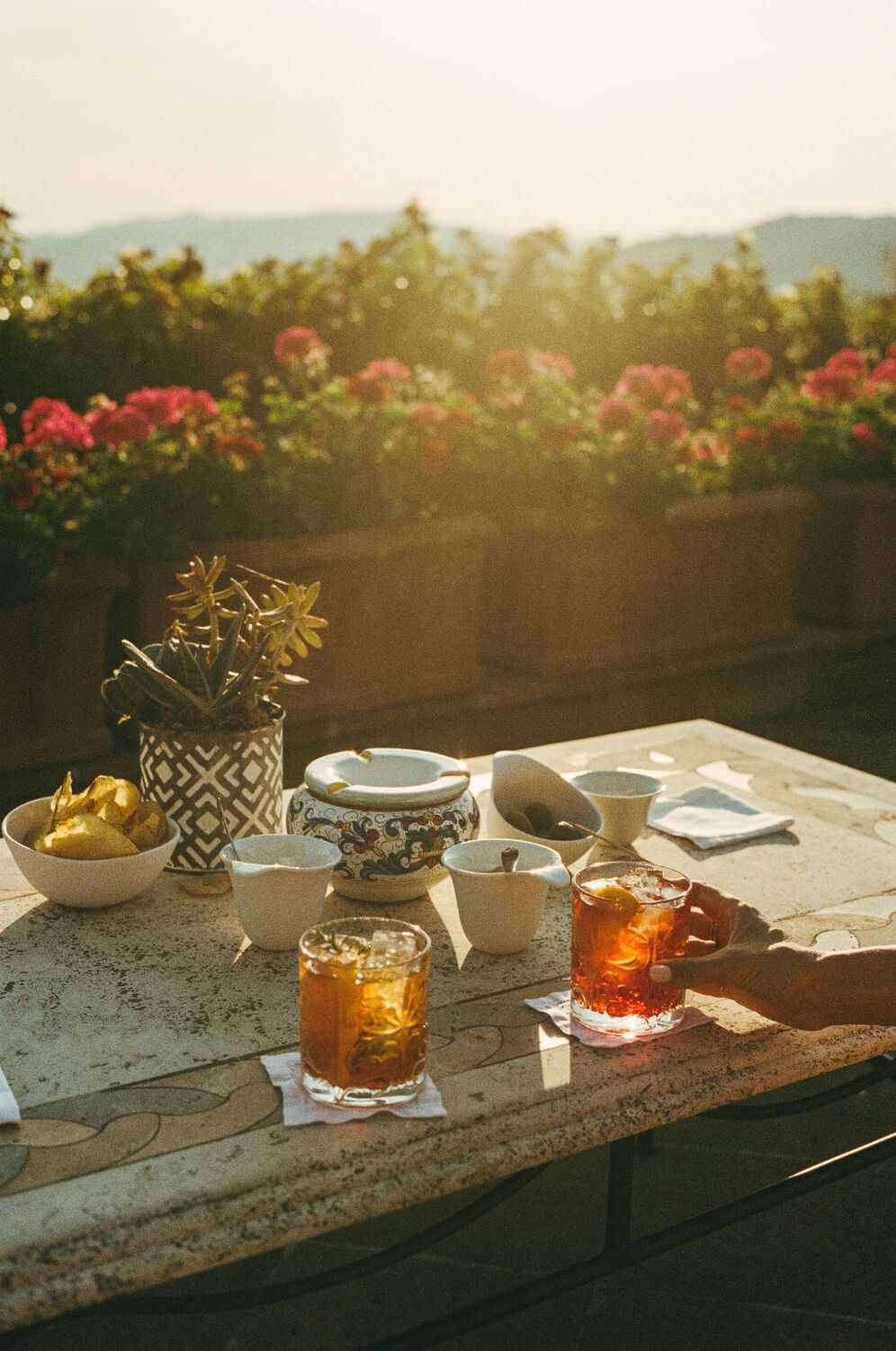 Aperitivo on a stone terrace at Castello di Casole.