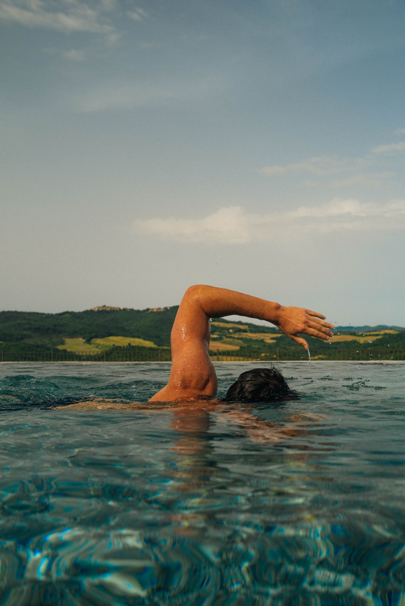 A swimmer in the infinity pool at Castello di Casole.
