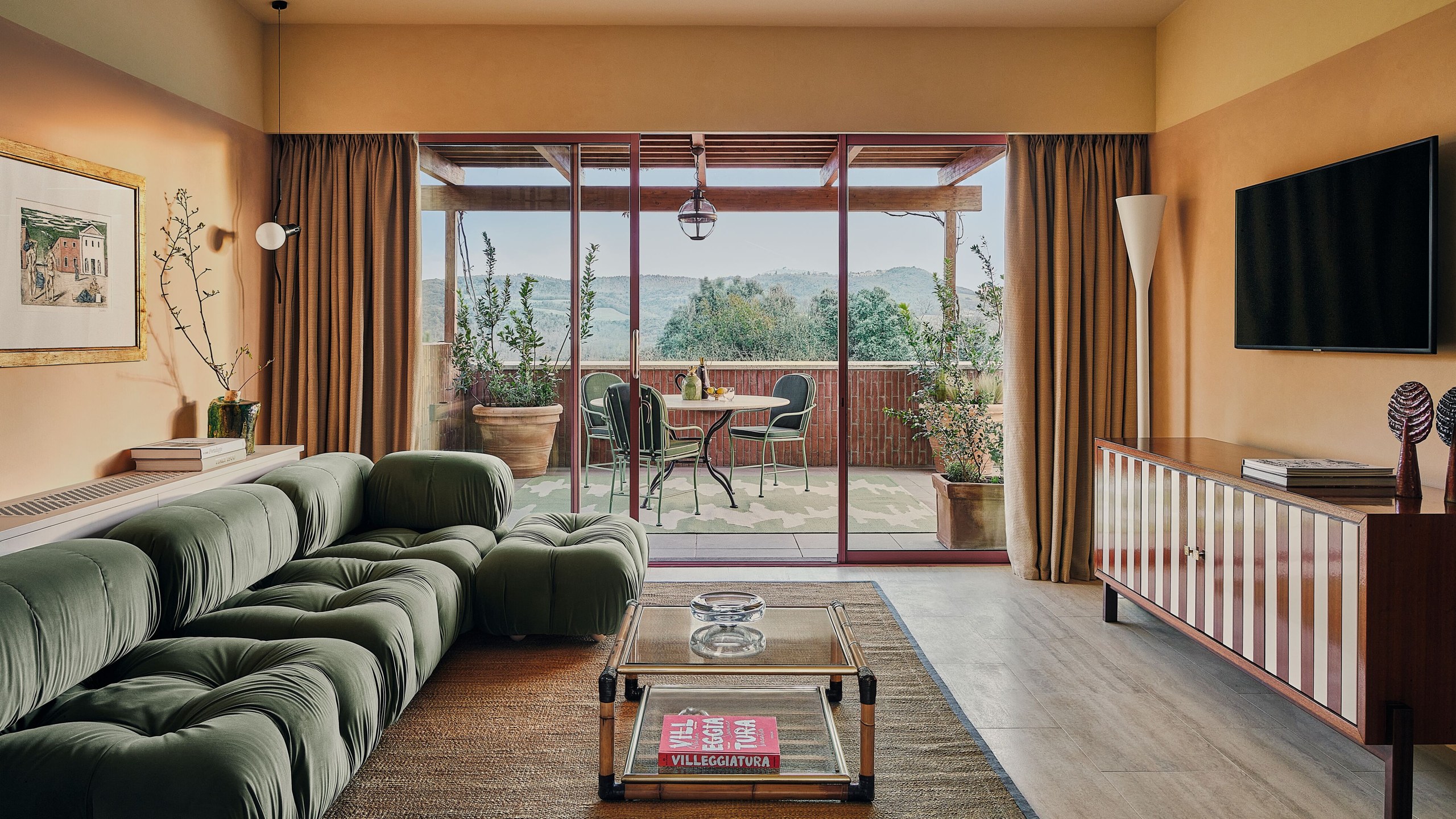 A suite lounge opening onto a terrace at Castello di Casole.