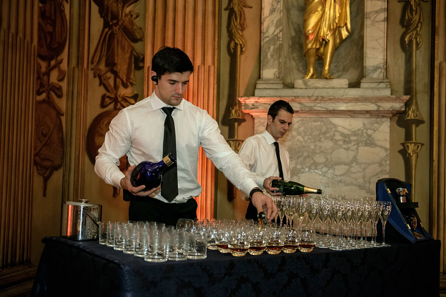 The drinks reception, glasses poured and set out on a side table.