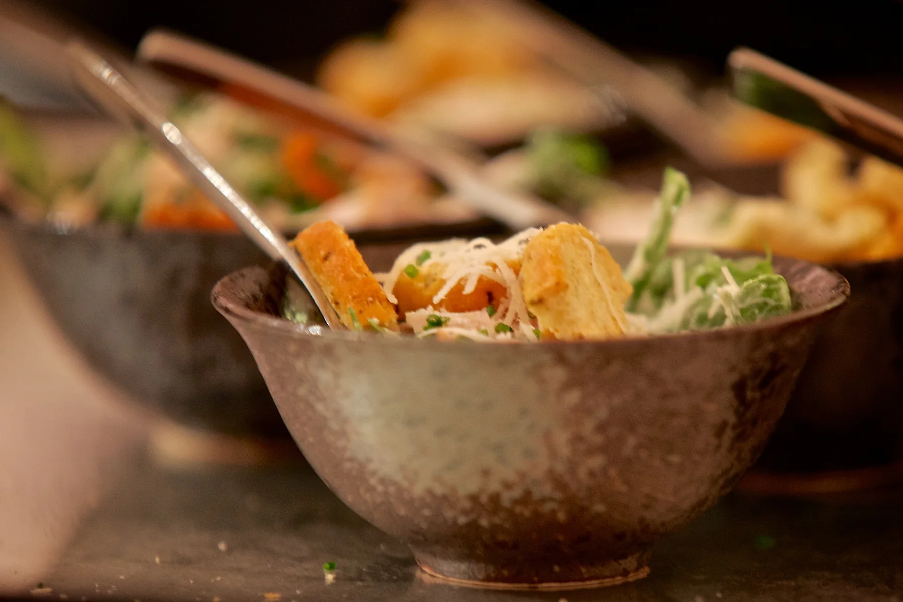 A bowl of food set on the table, shot close.