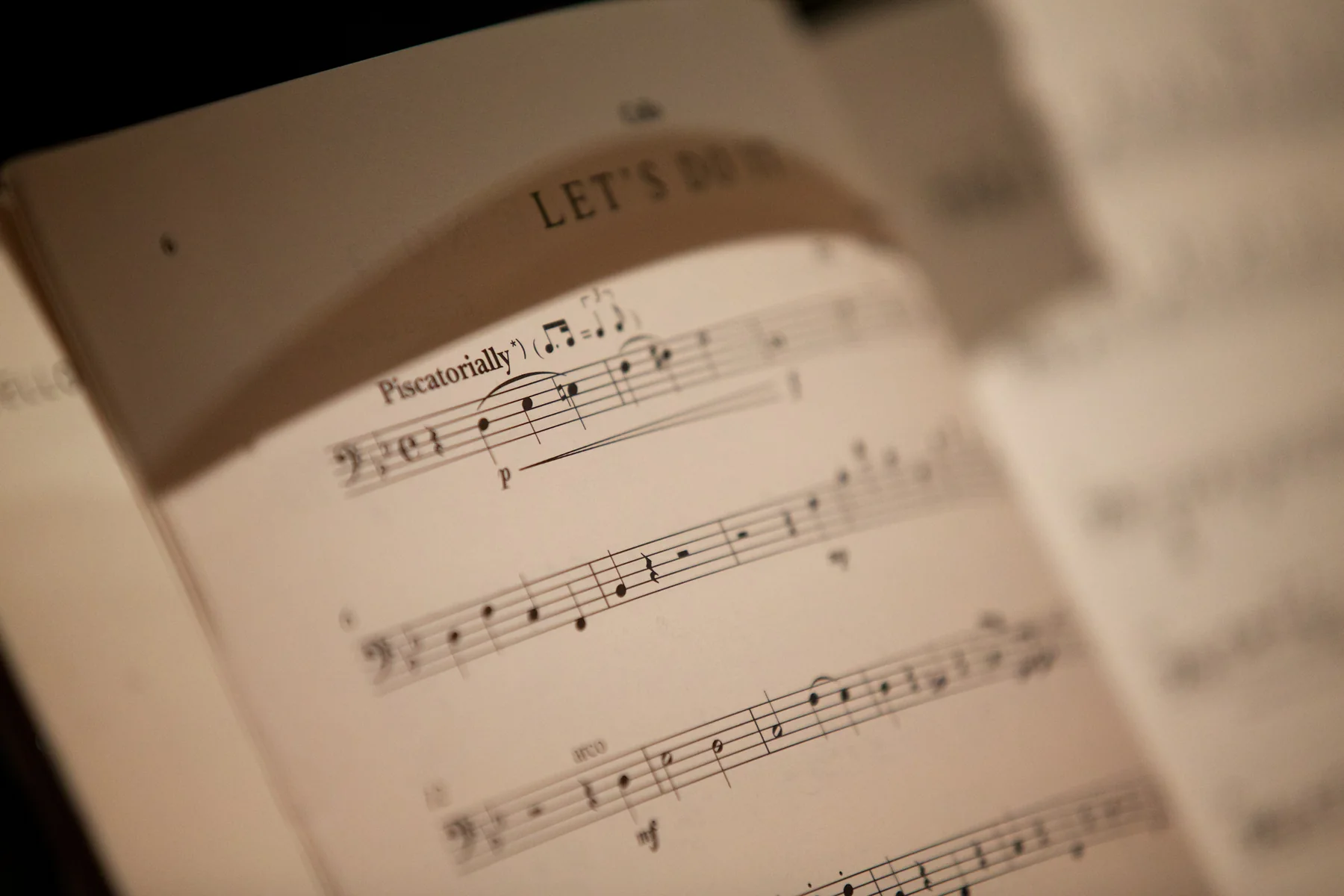 Open sheet music on a stand, the title LET'S DO IT legible across the top.
